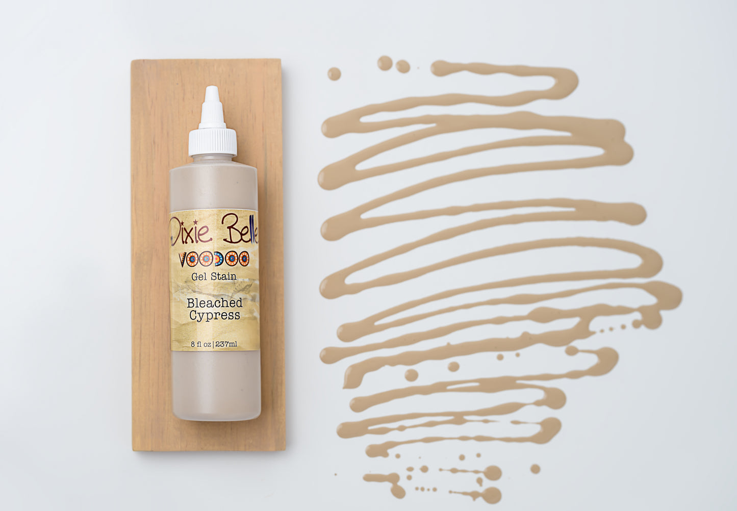 Dixie Belle VooDoo Gel Stain Bleached Cypress – 8 fl oz squeeze bottle on wood swatch with sandy greige gel swirl