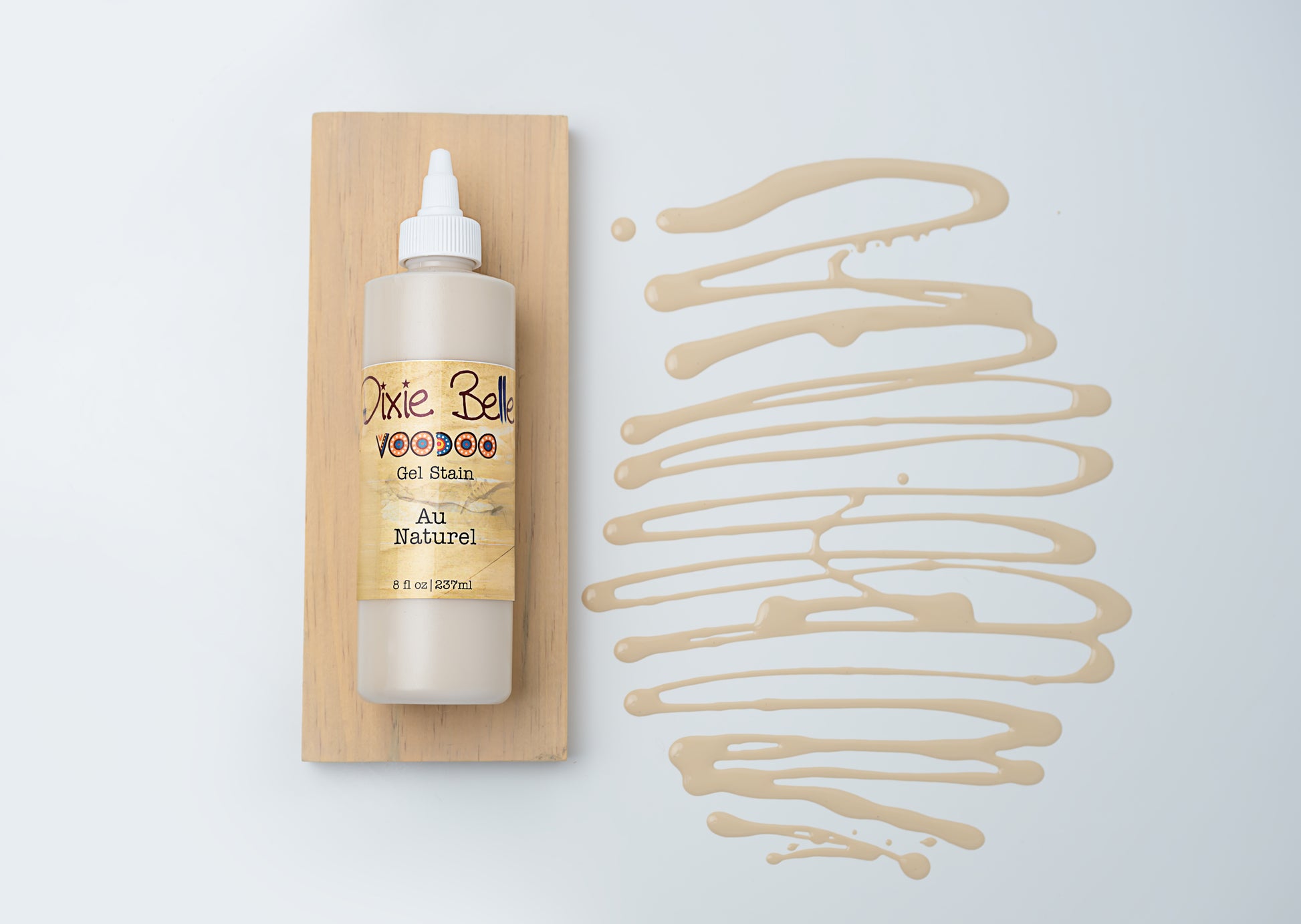 Dixie Belle VooDoo Gel Stain Au Naturel – 8 fl oz squeeze bottle on wood swatch with warm neutral gel swirl