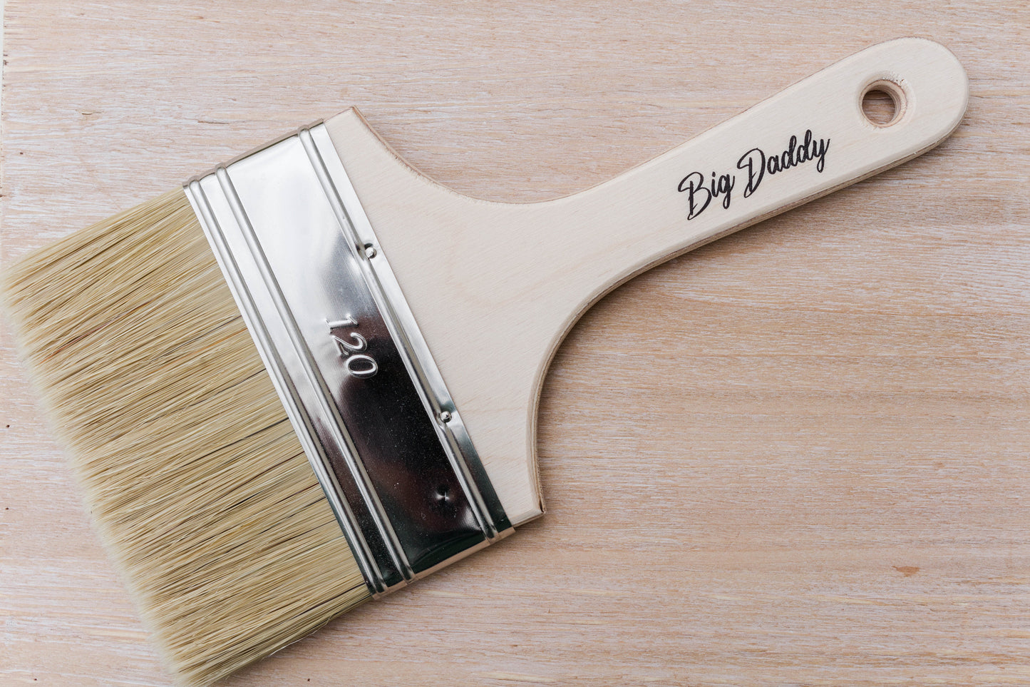Dixie Belle Big Daddy Brush – wide flat natural bristle brush with hardwood handle on a wood surface
