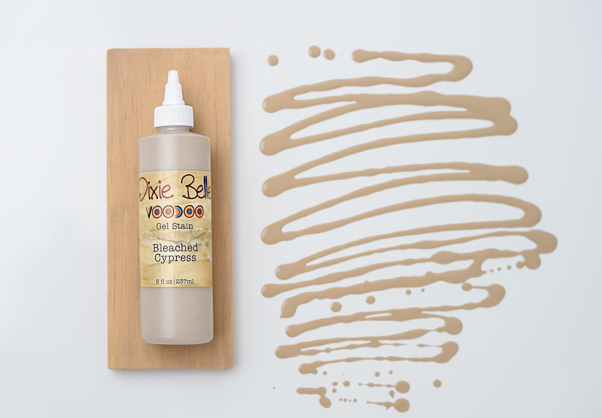 Dixie Belle VooDoo Gel Stain Bleached Cypress – 8 fl oz squeeze bottle on wood swatch with sandy greige gel swirl