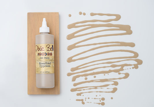 Dixie Belle VooDoo Gel Stain Bleached Cypress – 8 fl oz squeeze bottle on wood swatch with sandy greige gel swirl