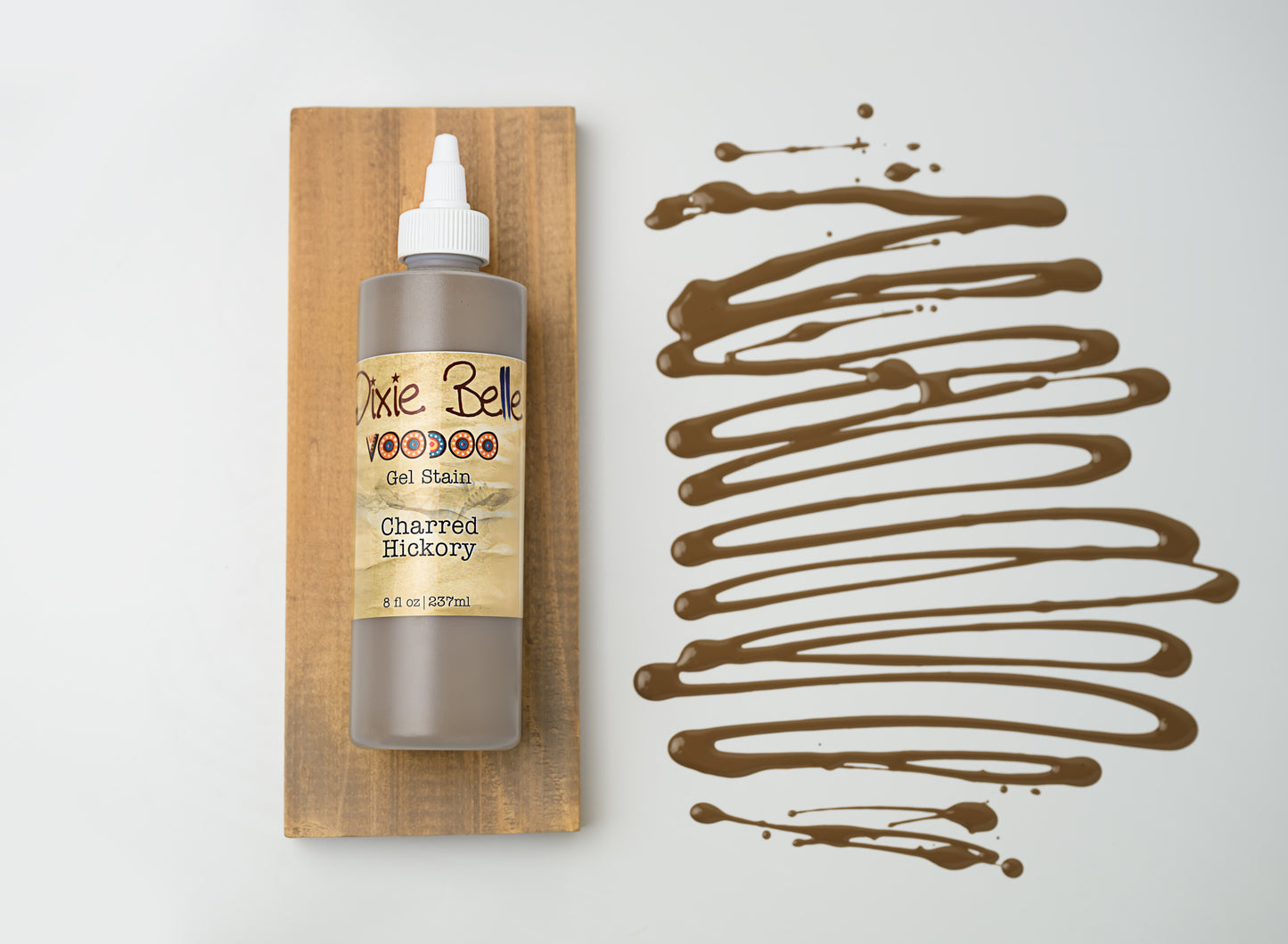 Dixie Belle VooDoo Gel Stain Charred Hickory – 8 fl oz squeeze bottle on wood swatch with deep warm brown gel swirl