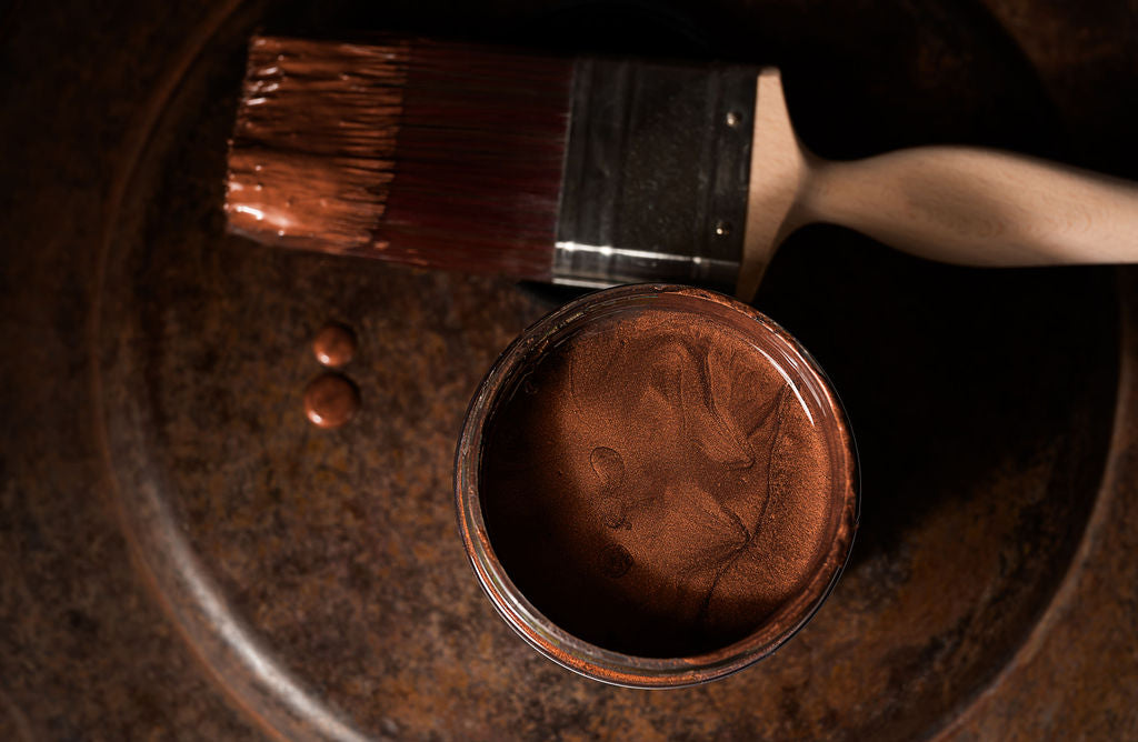 Dixie Belle Patina Paint Copper – open jar with brush showing rich copper metallic finish