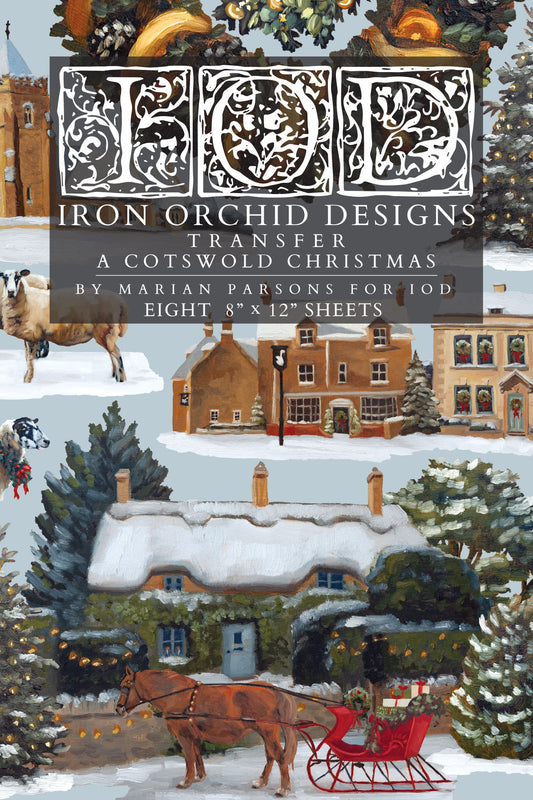 IOD A Cotswold Christmas Transfer front packaging — painterly English winter village scene with thatched cottage, horse-drawn sleigh, and snow-dusted trees by Marian Parsons