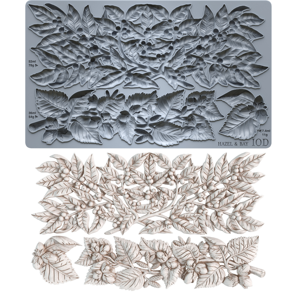 IOD Hazel & Bay Mould — grey silicone mould with three botanical cavities shown alongside finished white castings of berry garland, botanical branch spray, and accent cluster