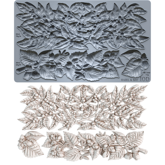 IOD Hazel & Bay Mould — grey silicone mould with three botanical cavities shown alongside finished white castings of berry garland, botanical branch spray, and accent cluster