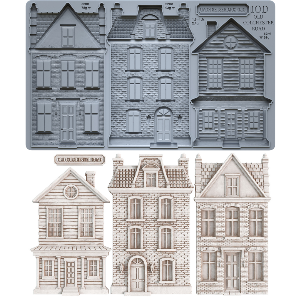 IOD Old Colchester Road Mould — grey silicone mould with three Victorian townhouse cavities and street sign plaque, shown with finished white castings of clapboard colonial, French brick townhouse, and Georgian row house