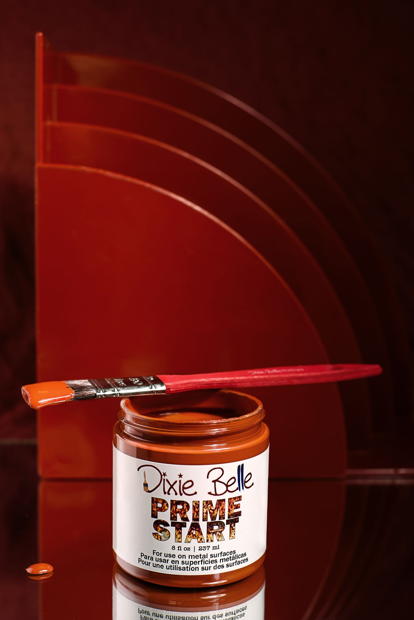 Dixie Belle Prime Start metal primer 8oz jar with brush on red background