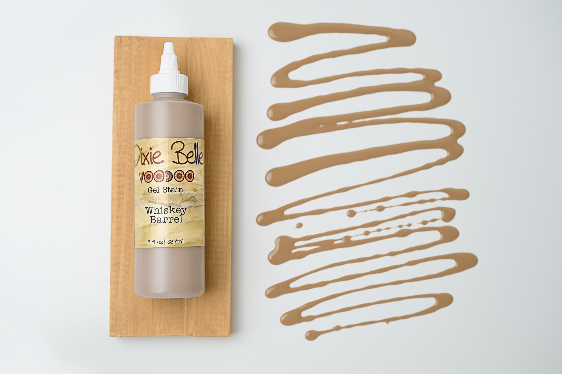 Dixie Belle VooDoo Gel Stain Whiskey Barrel – 8 fl oz squeeze bottle on wood swatch with warm golden-brown gel swirl